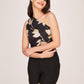 Confident pose with hands on waist, emphasizing the pintuck shoulder detail and the flattering high-waisted cut of the shorts.