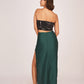 Back view of a satin co-ord set with a black tube top and a green skirt featuring a back zip closure