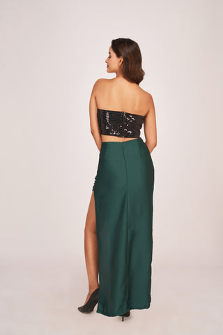 Back view of a satin co-ord set with a black tube top and a green skirt featuring a back zip closure