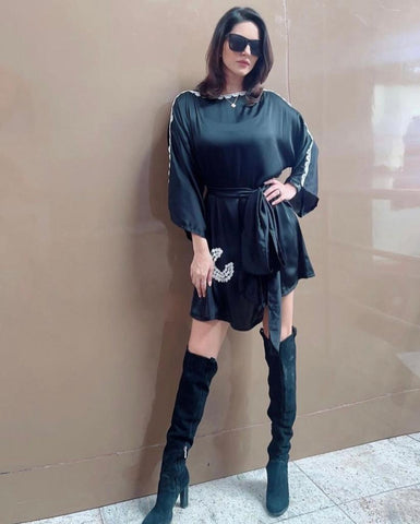 Belted black mini dress with shell embroidery and lace accents, perfect for parties and elegant nights out