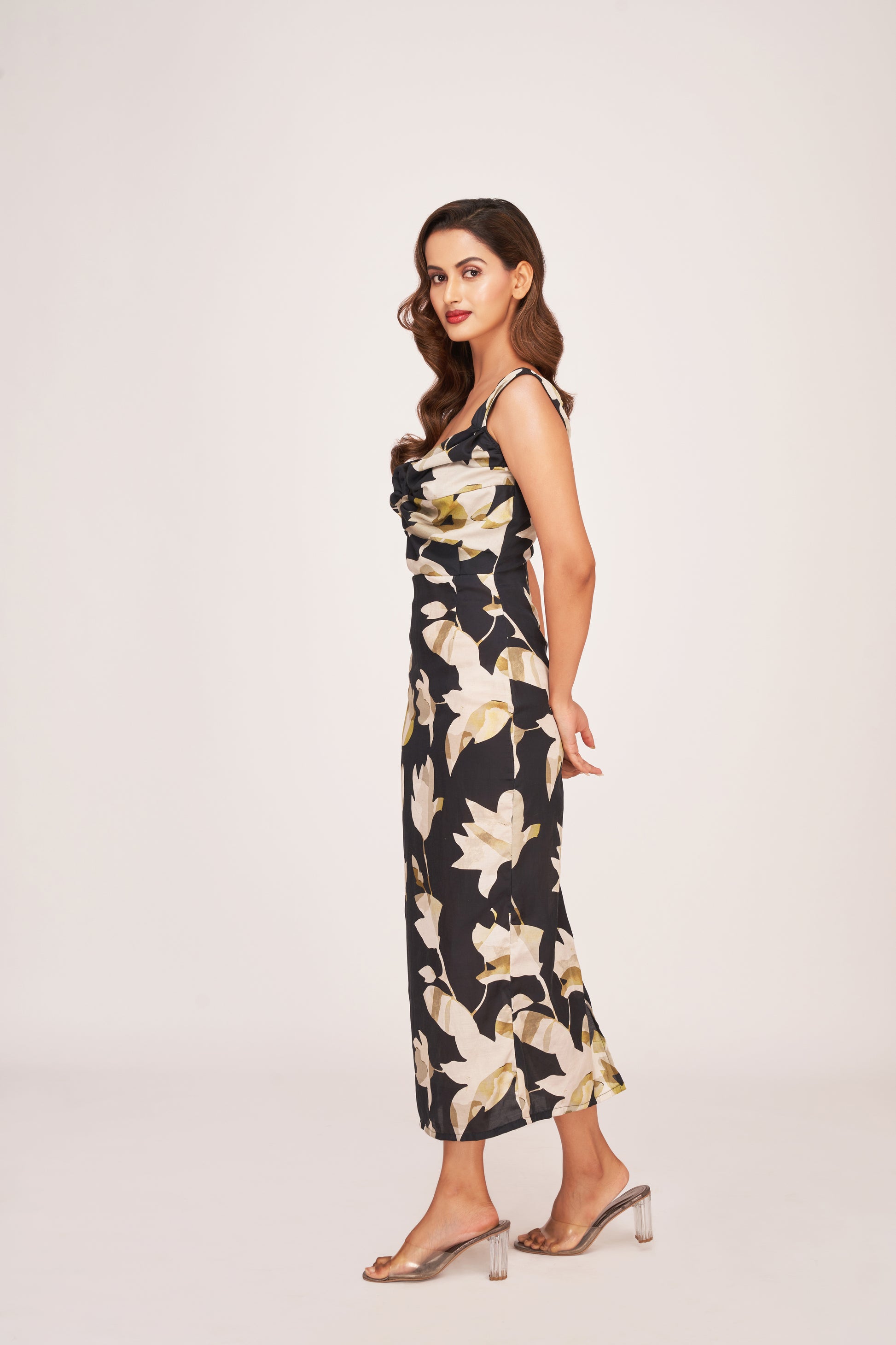 Model walking away in the black floral satin dress, offering a flowing back view and elegant stride.