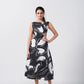 Model standing front-facing in black and white abstract print dress with sleeveless design and waist cut-outs.