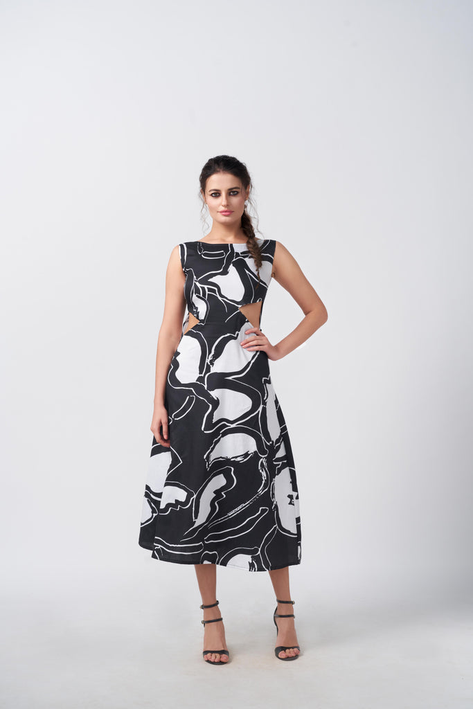 Model standing front-facing in black and white abstract print dress with sleeveless design and waist cut-outs.