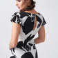 Close-up of ruffle sleeves and V-neckline in the black and white floral dress.