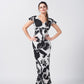 Model posing hands-on-hips, showcasing full silhouette of ankle-length floral crepe dress.