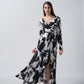 Model twirling to display the full flow and silhouette of the black and white crepe dress.