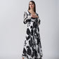Model walking forward with arms slightly bent, showcasing the relaxed elegance and flow of the dress.