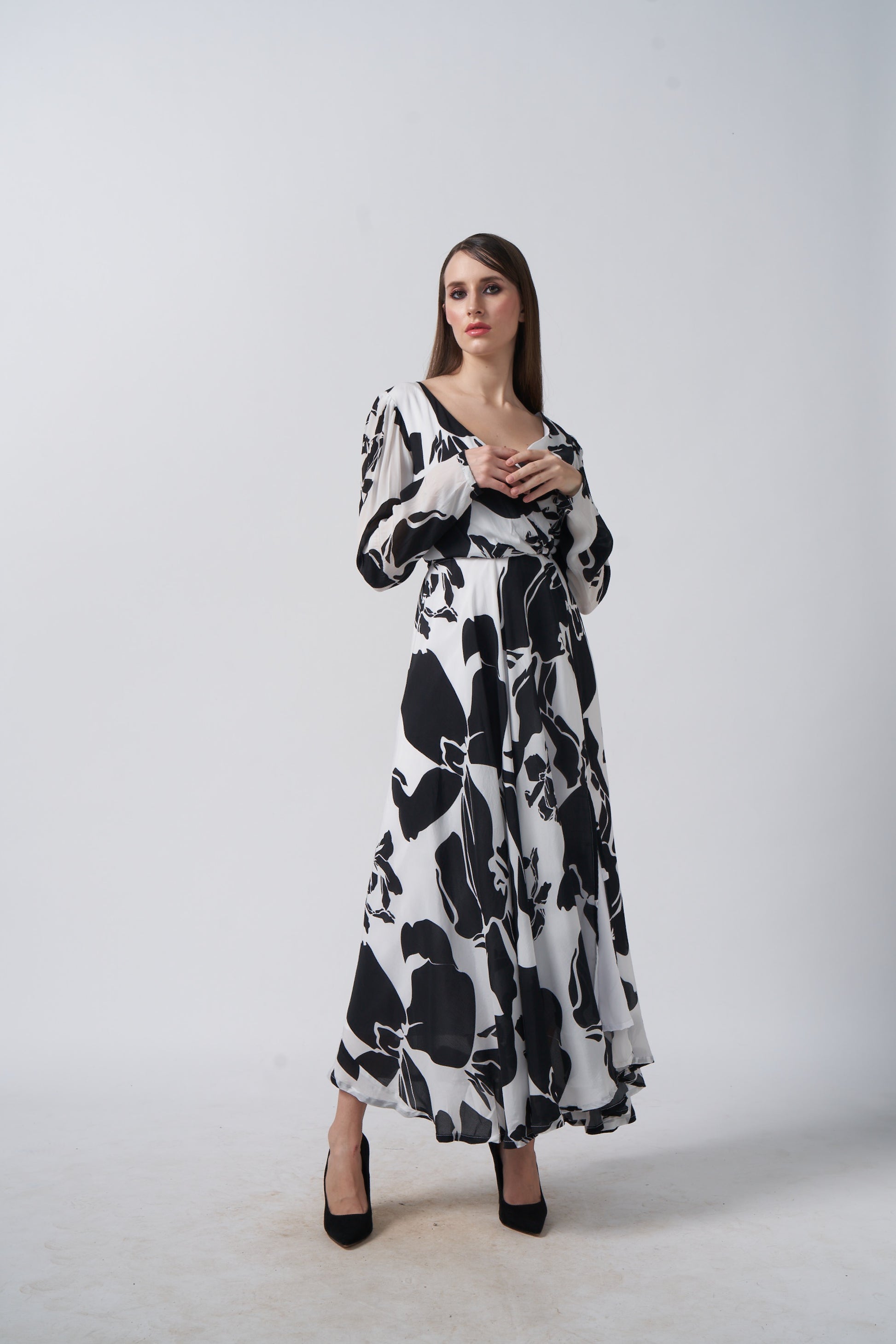 Model walking forward with arms slightly bent, showcasing the relaxed elegance and flow of the dress.