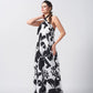 Model posing with hand on waist in black and white halter dress, showing the confident fit and fluid cut.