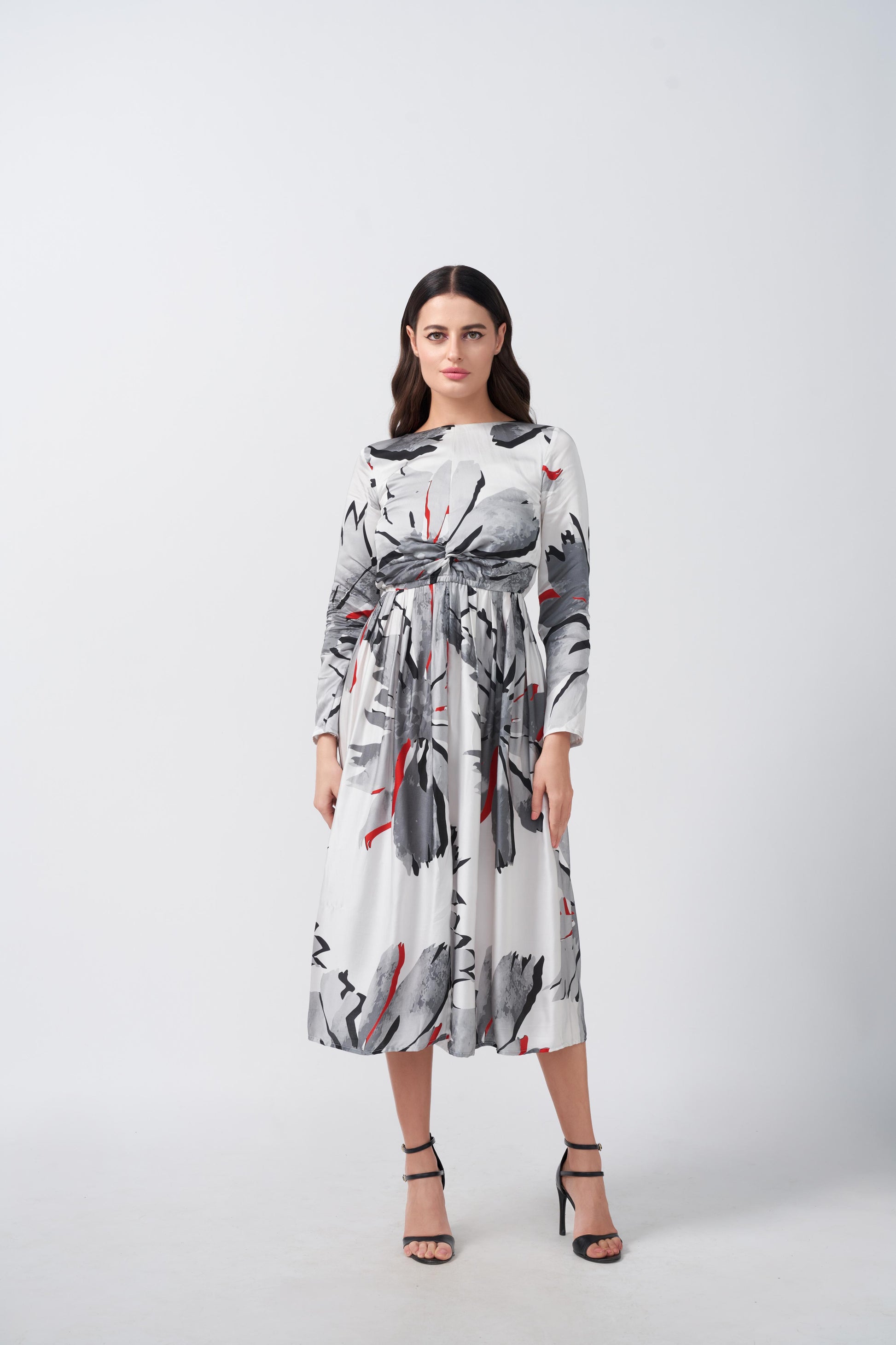 Full front view of model in a white and grey floral midi dress with long sleeves and a round neckline.