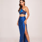 Model in mid-step pose flaunting the blue satin co-ord set, highlighting the flow of the slit skirt and cropped top.