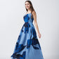 Side profile of model in halter neck blue floral crepe dress, highlighting the tie-back detail and flowy fabric.