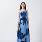 Model standing straight in light and dark blue floral halter crepe dress, showcasing the ankle-length silhouette.