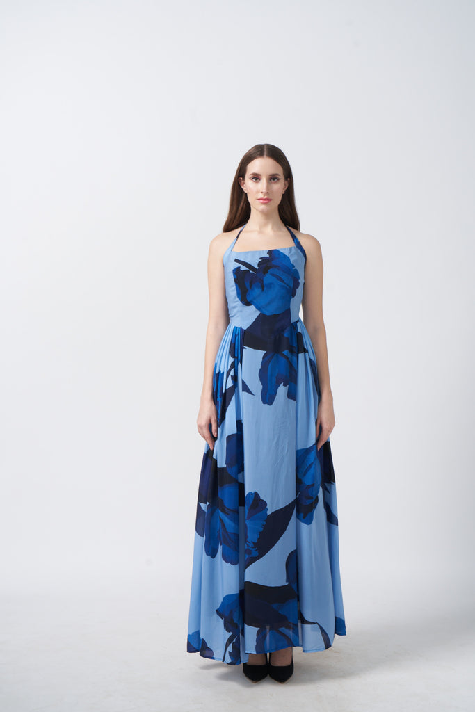 Model standing straight in light and dark blue floral halter crepe dress, showcasing the ankle-length silhouette.