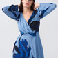 Model in light and dark blue floral crepe dress, focusing on neckline and sleeve detail.