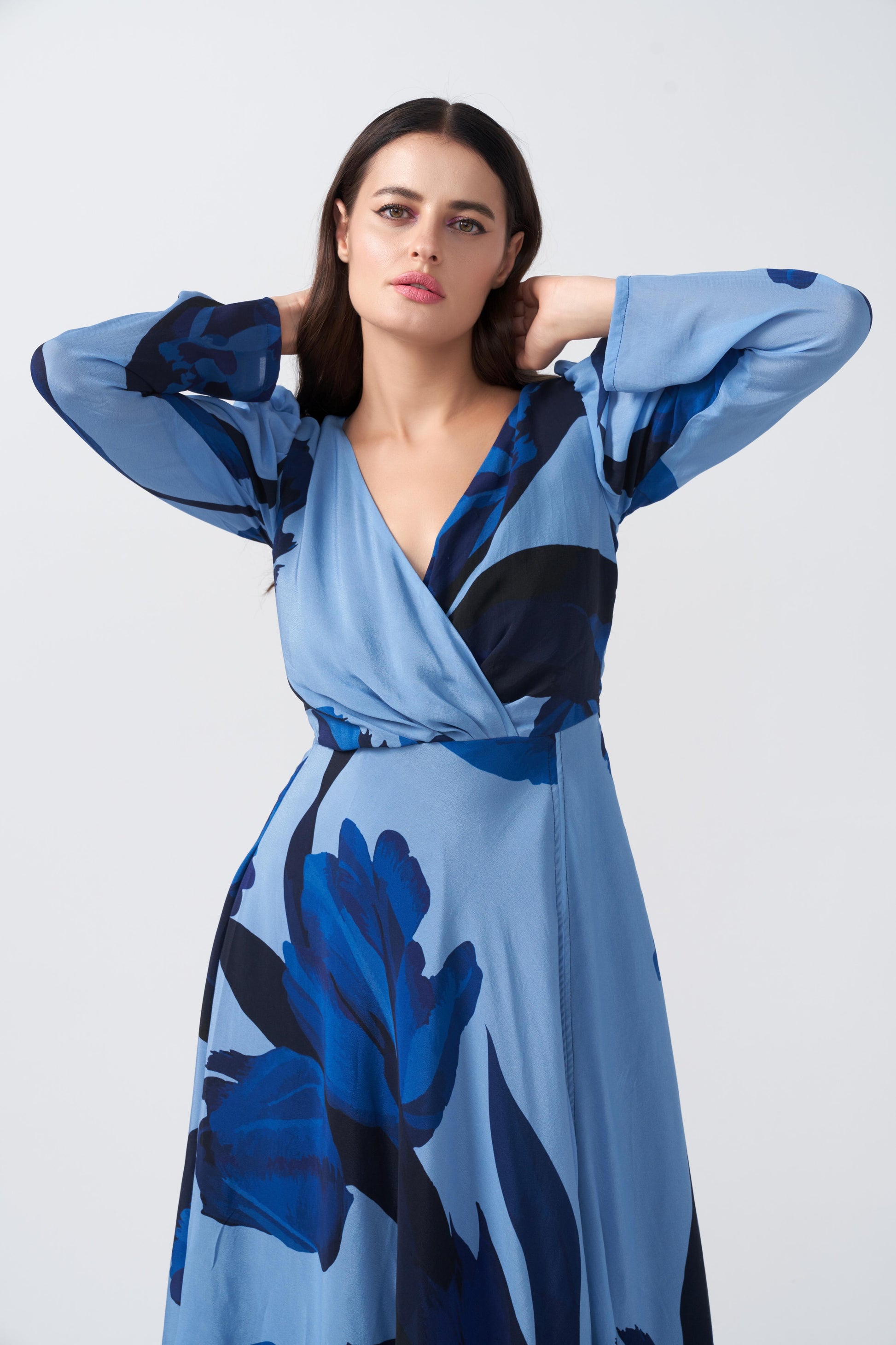Model in light and dark blue floral crepe dress, focusing on neckline and sleeve detail.