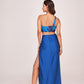 Rear angle showing the skirt's fit and one-shoulder crop top of the blue satin co-ord set.