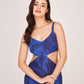 Sleeveless silk midi dress with a fluid drape and modern cut-out design