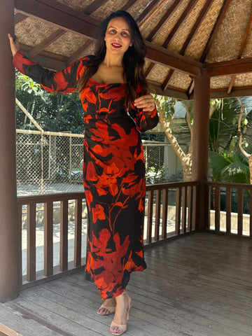 Ankle-length dress featuring a wide, structured square neckline and long sheer sleeves that create a refined and modest silhouette.