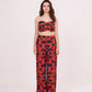 Model stands tall in colorful co-ord set with fitted V-neck crop top and relaxed parallel pants, showing a full front profile.