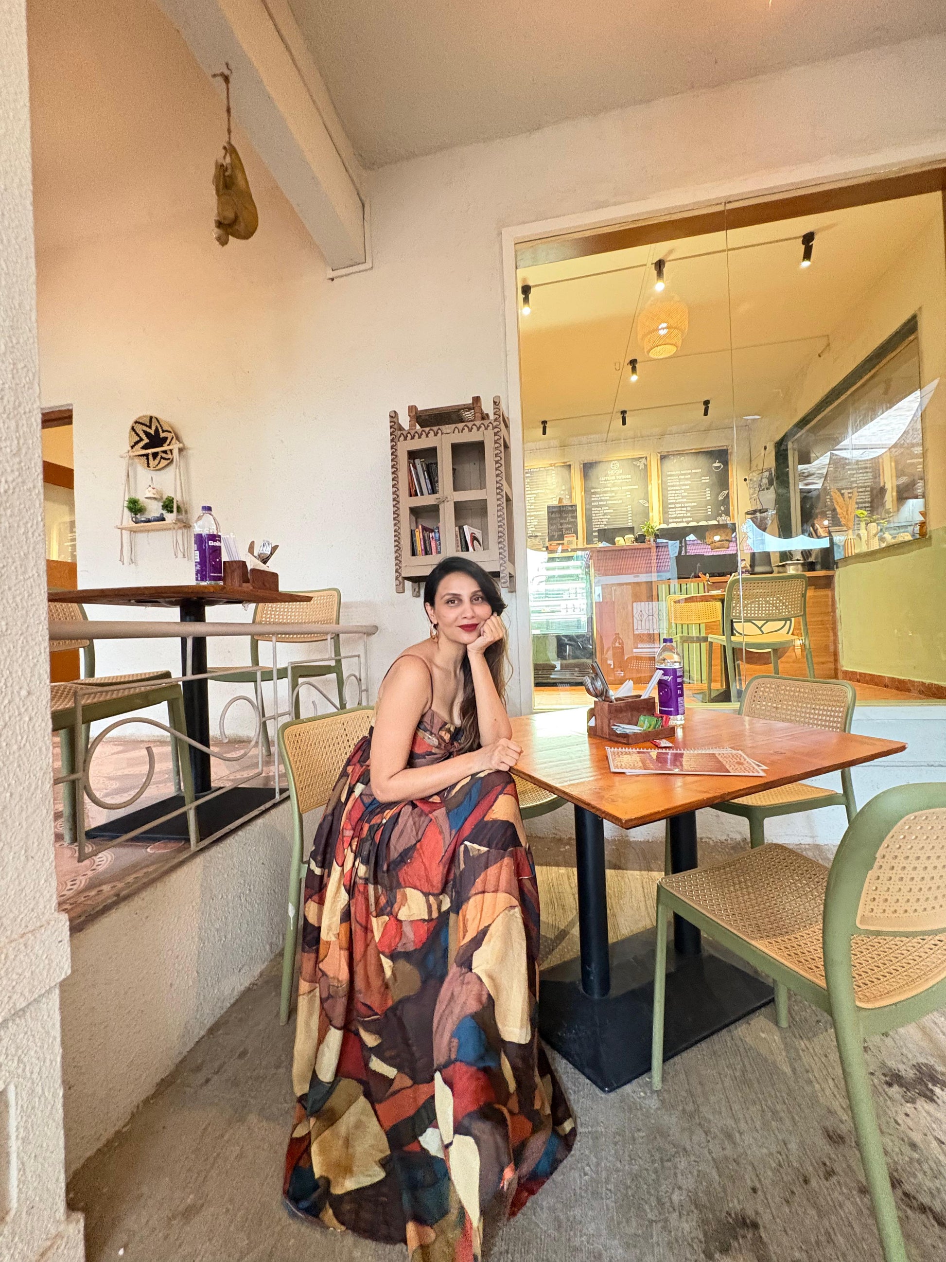 Strappy shoulder maxi dress with a bow detail and multicolored abstract print in earthy and vibrant tones