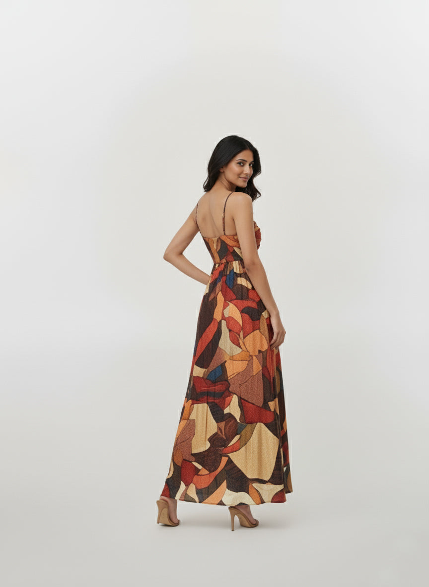 Back view of a strappy shoulder abstract print maxi dress with a flowing silhouette