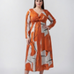 Plus size burnt orange and white abstract cotton satin midi dress with a twisted neckline and full sleeves