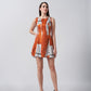 Model in sleeveless burnt orange and white cotton satin short dress, standing straight against a plain background.