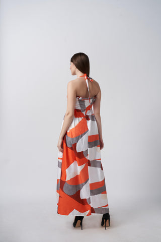 Back view of an ankle-length cotton satin dress with a halter tie-back neckline and fluid drape