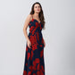 Model showing side profile of red and navy ruched chinon dress with ankle-length hemline.