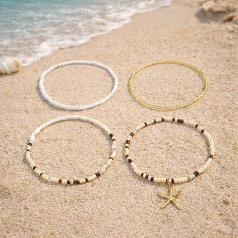 A versatile four-piece anklet set with a mix of minimalist gold chains and patterned earthy beads, an ideal accessory to coordinate with your favorite summer festival outfits.