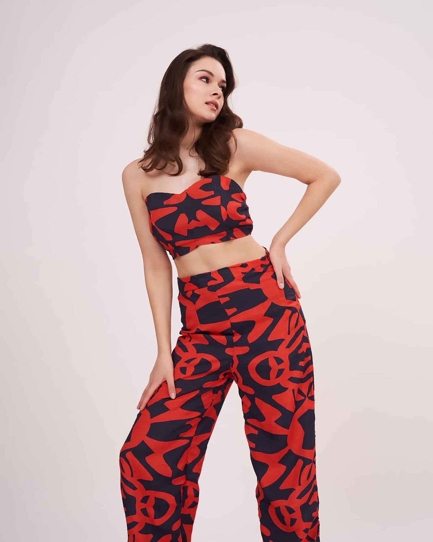 Confident pose in muslin printed co-ord set featuring sweetheart neckline and wide-leg pants with vibrant geometric design.
