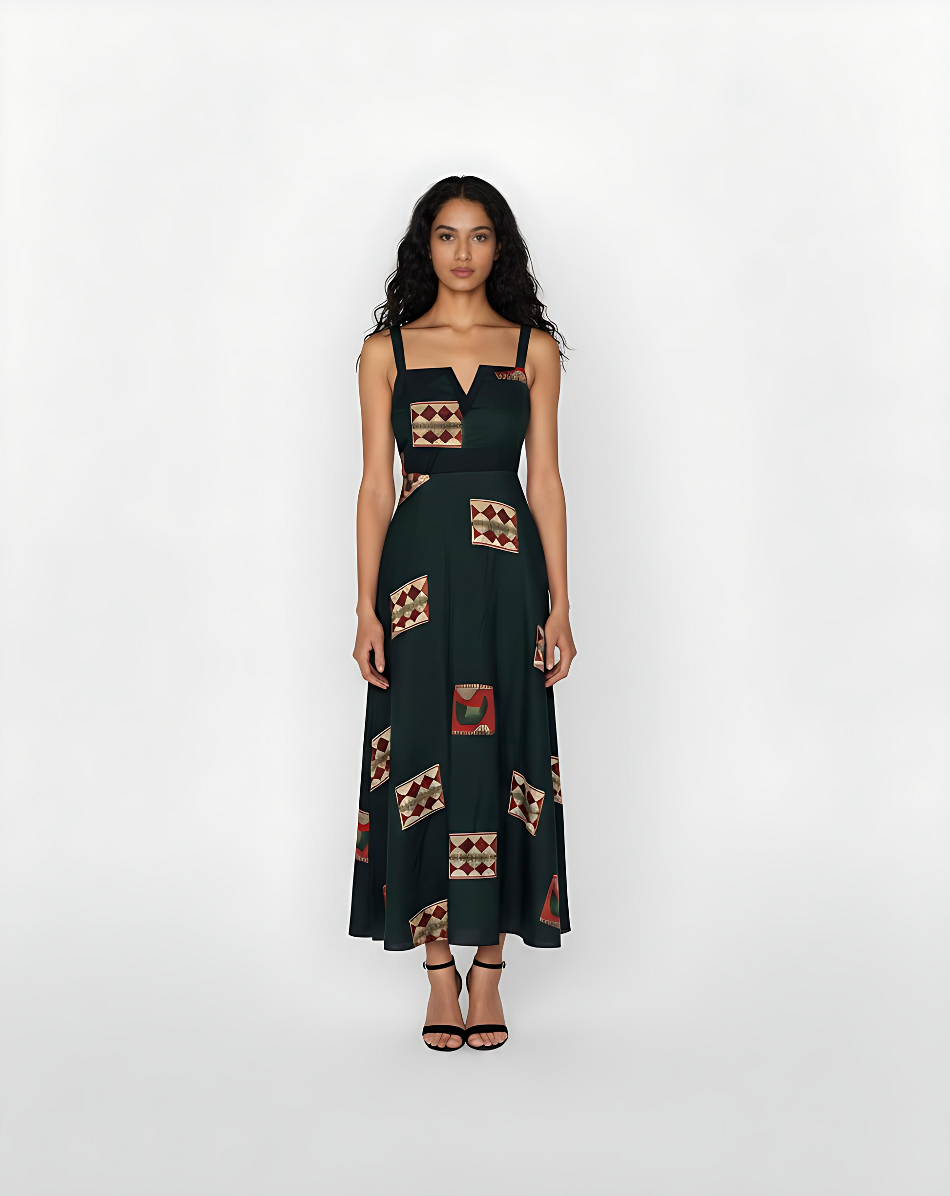 Ankle-length deep green crepe dress with wide shoulder straps, a notched square neckline, and geometric motifs in rust, beige, and maroon, suitable for elegant daytime events or artful evening gatherings.