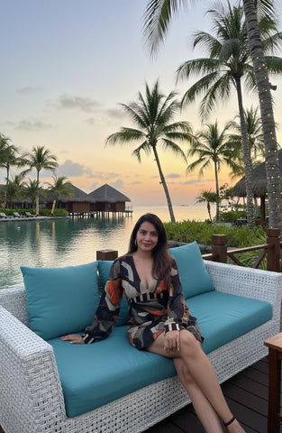 Mini dress with a deep V-neckline, long billowing sleeves, and a multicolored abstract print in earthy and vibrant tones