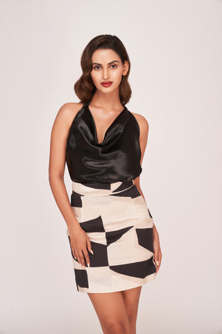 Full-length view of the two-piece set, combining a solid black top with an abstract printed skirt. 