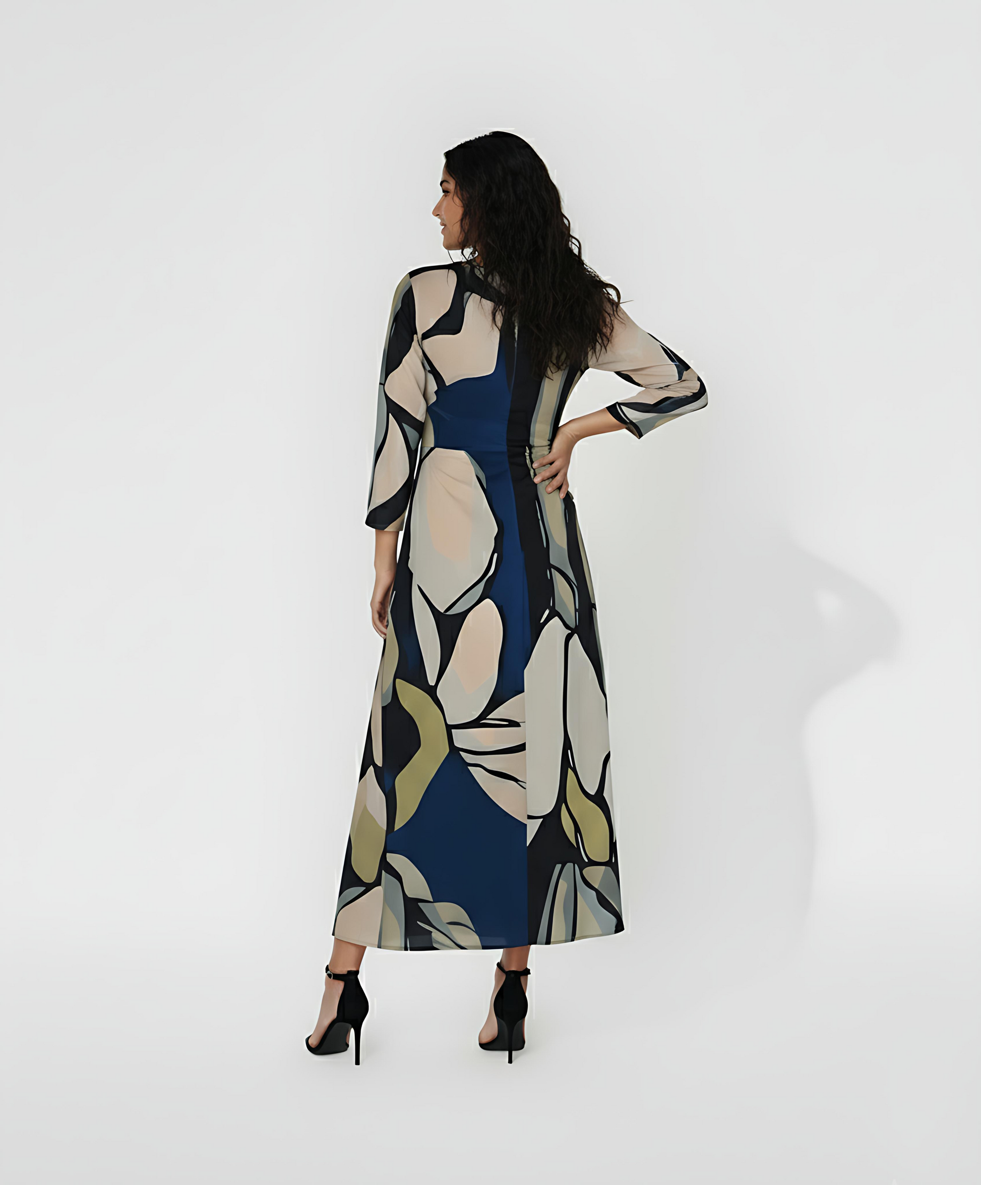 Ankle-length dress with a high, closed back and long fitted sleeves that emphasize a streamlined silhouette. The continuous abstract pattern flows across the entire back of the garment.