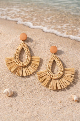 Brown rattan geometric earrings featuring a woven teardrop center and a fanned raffia base.