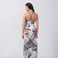 Back view of model wearing satin floral dress, highlighting halter tie-back neckline and elegant fit.