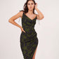 Walking pose of the model in green printed dress with strap shoulders and side split, showing movement and ruched detail.