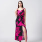 Model in a pink and black floral satin dress with front slit and knot detail at the waist.