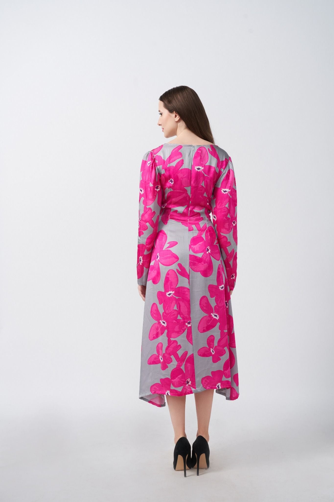 Rear view of the satin midi dress, displaying continuous floral pattern and sleek silhouette.