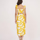 Rear view of the yellow printed co-ord set showing the ruched back detailing of the top and skirt with a full-length profile.