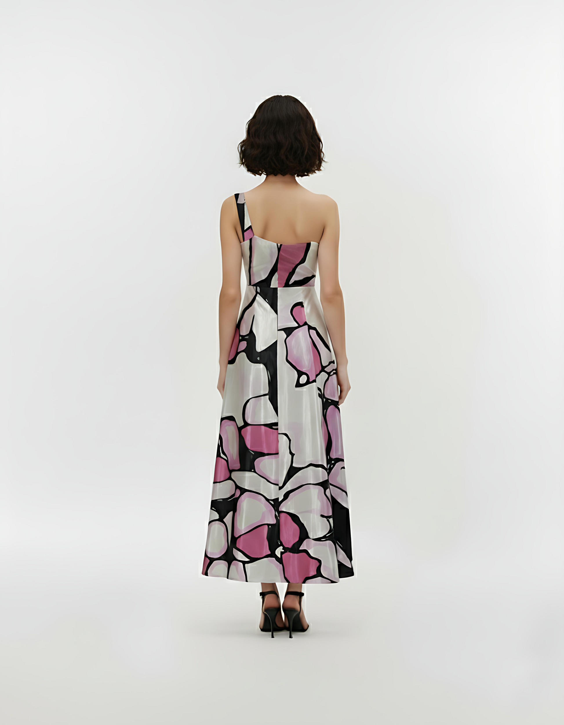 Back view of a one-shoulder crepe maxi dress featuring an asymmetric neckline, fitted waistband, and a flowy A-line silhouette.