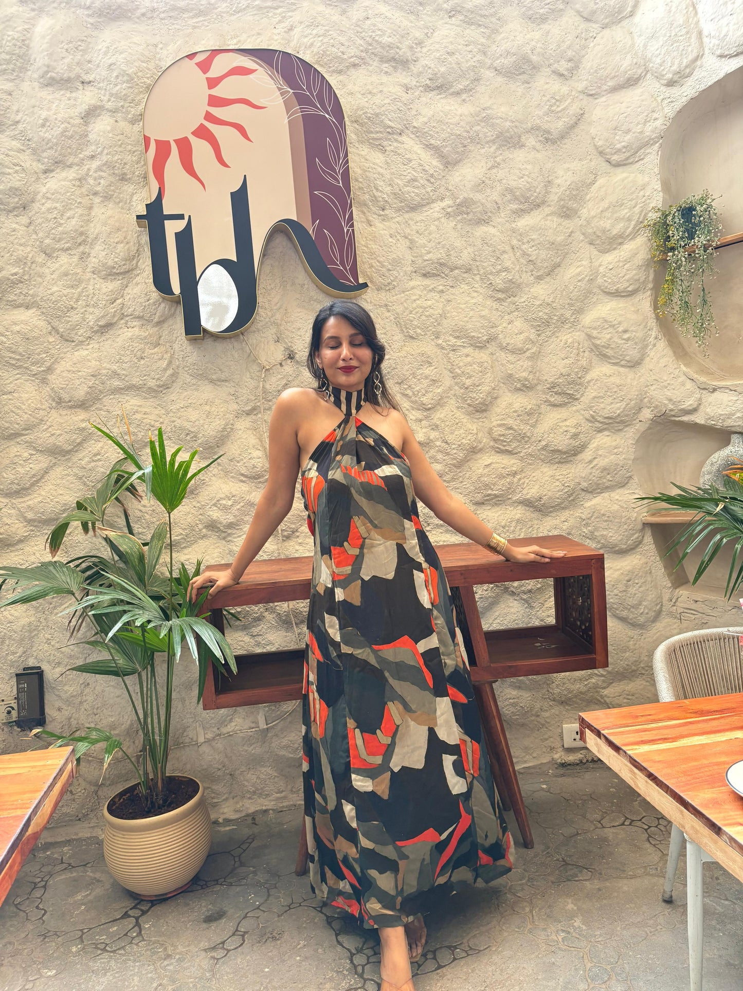 Abstract print maxi dress in deep navy, olive green, warm beige, and fiery orange tones