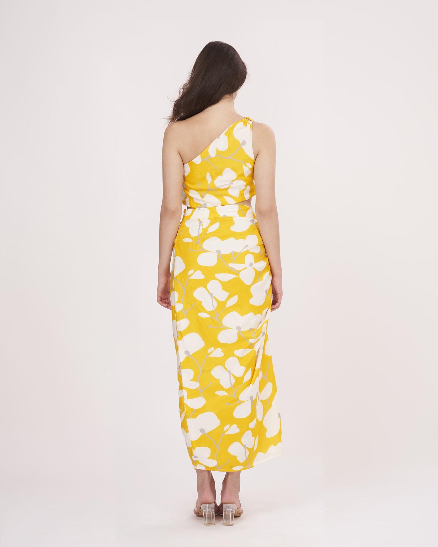 Rear view of the yellow floral co-ord set, showcasing the back cut of the skirt and the single-shoulder strap styling.