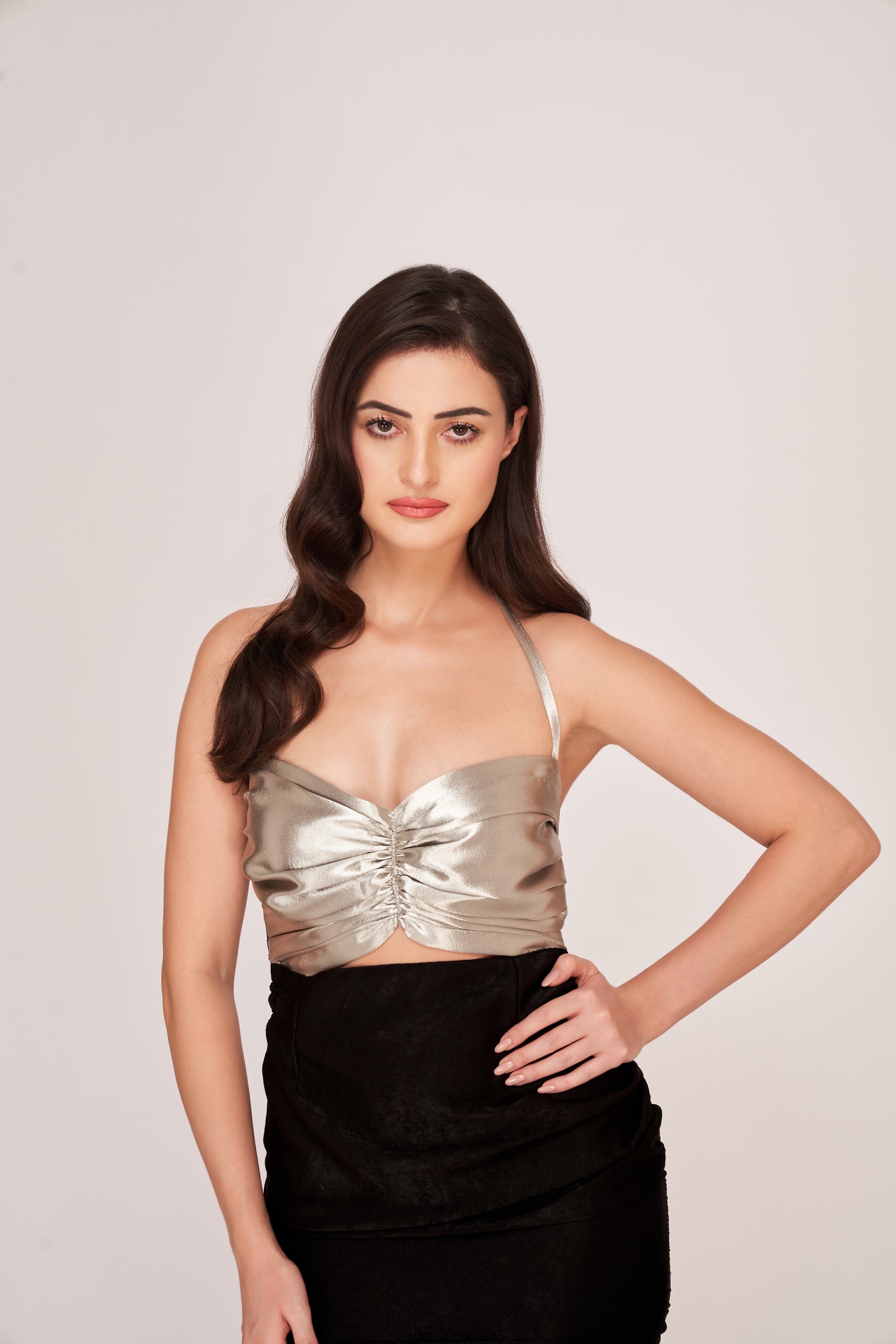  Model showcasing front cut-out and side ruched detailing in a black and silver sweetheart neck dress.
