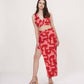 Slight angle stance showing the red co-ord’s bold print, flowy fabric, and flattering fit for summer occasions.