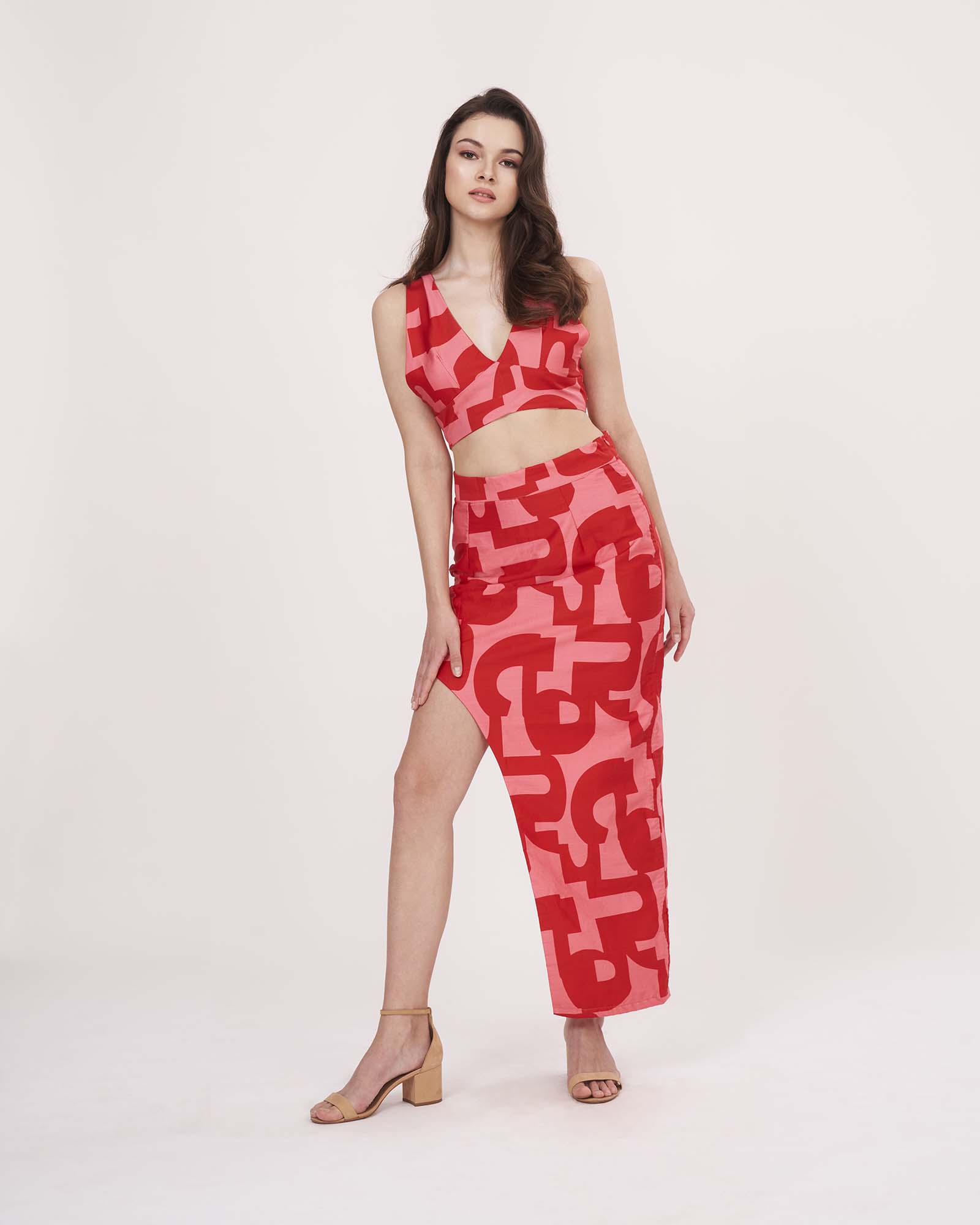 Slight angle stance showing the red co-ord’s bold print, flowy fabric, and flattering fit for summer occasions.
