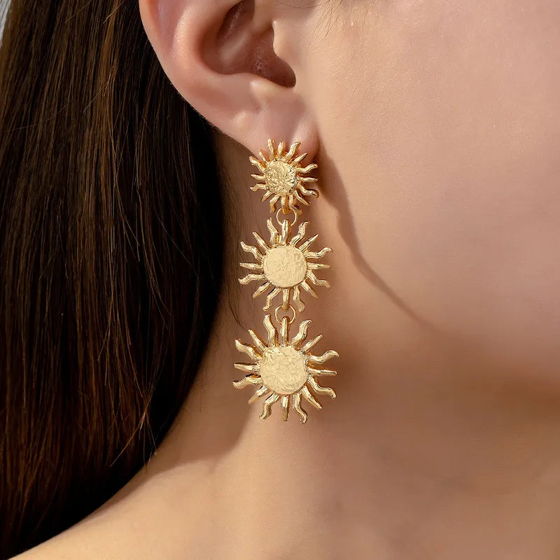 These radiant sun drop earrings dangle elegantly, catching the light with every turn of the head and making them an ideal statement piece for a beach wedding or a sun-drenched holiday brunch.