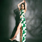 Model poses with one hand above the head, revealing the thigh-high slit and breezy silhouette of the green abstract print co-ord set.